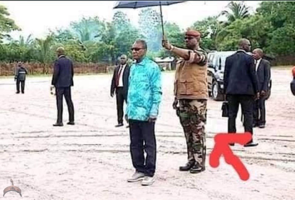 Guinea President umbrella holder removes him from Power